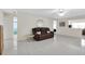 Living room featuring a brown leather couch and tile floors at 4737 Sandpointe Dr, New Port Richey, FL 34655