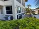 Exterior of condo unit showing windows, AC unit, and landscaping at 5142 Topaz Ln # 103, New Port Richey, FL 34652