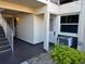 Exterior view of condo building entrance with stairs and landscaping at 5142 Topaz Ln # 103, New Port Richey, FL 34652