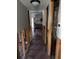 Hallway under renovation with exposed framing and new flooring at 5142 Topaz Ln # 103, New Port Richey, FL 34652