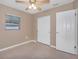 Bright bedroom with ceiling fan and double-door closet at 5931 Pine St, New Port Richey, FL 34652