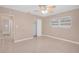 Well-lit bedroom featuring a ceiling fan and bathroom access at 5931 Pine St, New Port Richey, FL 34652