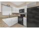 Modern kitchen with white cabinets, granite countertops and black appliances at 5931 Pine St, New Port Richey, FL 34652
