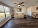 Living room with laminate floors, a sofa, and two armchairs at 6422 Tralee Ave, New Port Richey, FL 34653