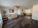 Living room with laminate flooring, a sofa, and two armchairs at 6422 Tralee Ave, New Port Richey, FL 34653