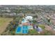 Aerial view of community featuring tennis courts and pond at 6604 Spring Flower Dr # 23, New Port Richey, FL 34653
