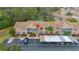 Aerial view of condo building, showing parking and surrounding trees at 6604 Spring Flower Dr # 23, New Port Richey, FL 34653