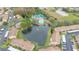 Aerial view of community with pool, tennis courts, and pond at 6604 Spring Flower Dr # 23, New Port Richey, FL 34653