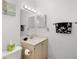 Bathroom with vanity, toilet and a large mirror at 6604 Spring Flower Dr # 23, New Port Richey, FL 34653