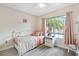Bedroom with a daybed, nightstand, and large window at 6604 Spring Flower Dr # 23, New Port Richey, FL 34653