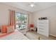 Cozy bedroom with a dresser and window offering natural light at 6604 Spring Flower Dr # 23, New Port Richey, FL 34653