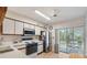 Bright kitchen with stainless steel appliances and access to a balcony at 6604 Spring Flower Dr # 23, New Port Richey, FL 34653