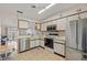 Open kitchen features stainless steel appliances and view into living room at 6604 Spring Flower Dr # 23, New Port Richey, FL 34653