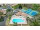 Community pool area with lounge chairs and clubhouse at 6604 Spring Flower Dr # 23, New Port Richey, FL 34653