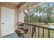 Screened balcony with table and chairs, overlooking a backyard and pool at 6604 Spring Flower Dr # 23, New Port Richey, FL 34653