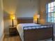 Guest bedroom with wicker bed frame and large window at 6734 Dali Ave # 206, Land O Lakes, FL 34637