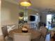 Elegant dining area, featuring a round table with chairs and a large mirror reflecting the living room at 6734 Dali Ave # 206, Land O Lakes, FL 34637