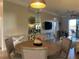Round dining table with four chairs in condo, hardwood floors, and modern light fixture at 6734 Dali Ave # 206, Land O Lakes, FL 34637