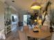 Bright dining area with round table and chairs, hardwood floors, and large mirror at 6734 Dali Ave # 206, Land O Lakes, FL 34637