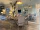 Condo dining area with round table, four chairs, and a view of the living room at 6734 Dali Ave # 206, Land O Lakes, FL 34637