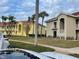 Exterior view of a two-story building with palm trees and landscaping at 6734 Dali Ave # 206, Land O Lakes, FL 34637