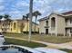 Two-story condo building with palm trees and landscaped grounds at 6734 Dali Ave # 206, Land O Lakes, FL 34637