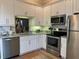 Modern kitchen with stainless steel appliances and granite countertops at 6734 Dali Ave # 206, Land O Lakes, FL 34637