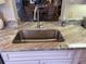 Stainless steel sink with granite countertop in modern kitchen at 6734 Dali Ave # 206, Land O Lakes, FL 34637