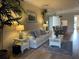 Living room with sofa, coffee table, and view into dining area at 6734 Dali Ave # 206, Land O Lakes, FL 34637