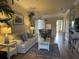 Bright living room features hardwood floors, comfy sofa, and access to balcony at 6734 Dali Ave # 206, Land O Lakes, FL 34637