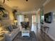Open living space with light colored sofa and hardwood floors at 6734 Dali Ave # 206, Land O Lakes, FL 34637