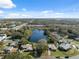 Aerial view showcases home's location near a lake at 6920 Medlar Dr, New Port Richey, FL 34653