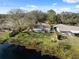 Aerial view showing house, backyard, and lake access at 6920 Medlar Dr, New Port Richey, FL 34653