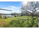 Spacious backyard with large tree and lake view at 6920 Medlar Dr, New Port Richey, FL 34653