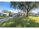House exterior with a tree-lined yard and American flag at 6920 Medlar Dr, New Port Richey, FL 34653