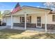 Front view of a house with an American flag and stone accents at 6920 Medlar Dr, New Port Richey, FL 34653