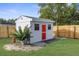 Detached shed with red door and white exterior at 7298 Blackhawk Trl, Spring Hill, FL 34606