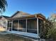 Spacious screened porch with ceiling fan and sliding glass doors at 7830 Becket St, New Port Richey, FL 34653