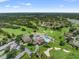 Aerial view showing community pool, clubhouse, and golf course at 8016 Willow Brook Dr, Spring Hill, FL 34606