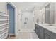 Walk in shower with marble tile and grey vanity at 8016 Willow Brook Dr, Spring Hill, FL 34606