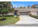 Front view of charming villa with a two-car garage at 8016 Willow Brook Dr, Spring Hill, FL 34606