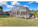 Private backyard with large screened patio and grassy area at 8148 Ambersweet Pl, Land O Lakes, FL 34637