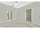Bedroom with ceiling fan and access to bathroom at 8148 Ambersweet Pl, Land O Lakes, FL 34637