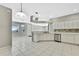 Open kitchen with island, white cabinets, and tile floor at 8148 Ambersweet Pl, Land O Lakes, FL 34637