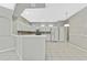Kitchen features white cabinets, tile floors, and stainless steel appliances at 8148 Ambersweet Pl, Land O Lakes, FL 34637