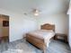 Bedroom with wood bed frame and ceiling fan, plus a large closet at 8177 Philatelic Dr, Spring Hill, FL 34606