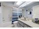 Clean bathroom with shower/tub, vanity, and striped curtain at 8350 High Point Cir # 3, Port Richey, FL 34668