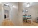 Bright dining area with table and chairs, view into hallway at 8350 High Point Cir # 3, Port Richey, FL 34668
