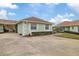 View of a light green villa with garage door open, showing the interior at 8350 High Point Cir # 3, Port Richey, FL 34668