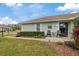Light green house exterior with small patio and landscaping at 8350 High Point Cir # 3, Port Richey, FL 34668